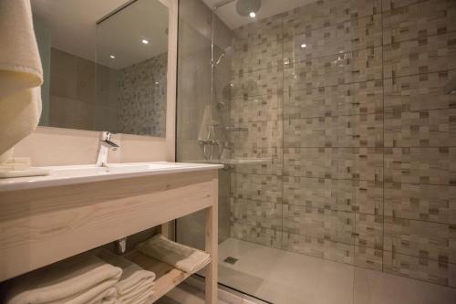 a bathroom with a sink and a shower at Stratovarius Nissi Rooms in Ayia Napa