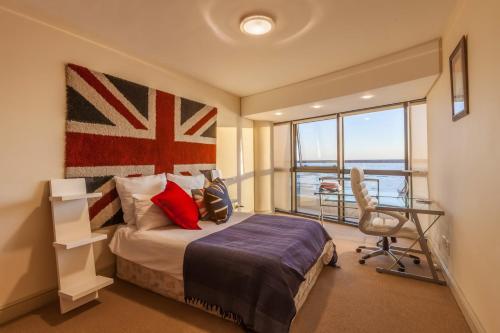 1 dormitorio con 1 cama con bandera en la pared en Ocean View 201A, en Strand