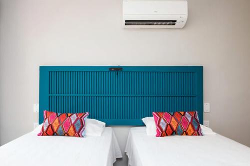 Postel nebo postele na pokoji v ubytování Icaraí Suítes