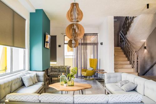 a living room with a couch and a table at Natali Apartments by Estia in Malia