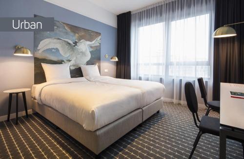 a hotel room with a bed and a large window at Corendon Urban Amsterdam Schiphol Airport Hotel in Badhoevedorp