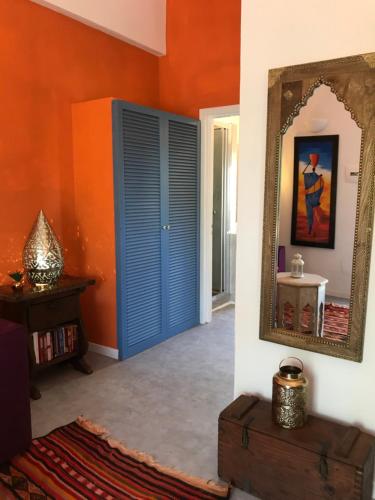a room with a blue door and a mirror at Le Lanterne Resort in Pantelleria