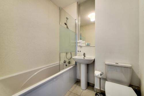 a bathroom with a sink and a toilet and a shower at No.5 Serviced Apartment in Glasgow