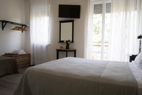 a bedroom with a white bed and a window at Soleluna Locazione Turistica in Verona