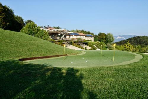 a golf course with two putts on a green at Relais Rossar Boutique Hotel Garda & Hills in Costermano sul Garda