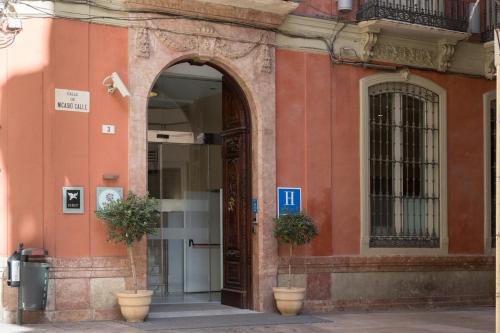 an entrance to a building with an open door at Petit Palace Plaza Málaga in Málaga