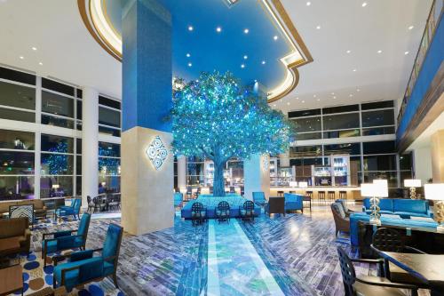 a hotel lobby with a christmas tree in the center at Fairmont Austin Gold Experience in Austin