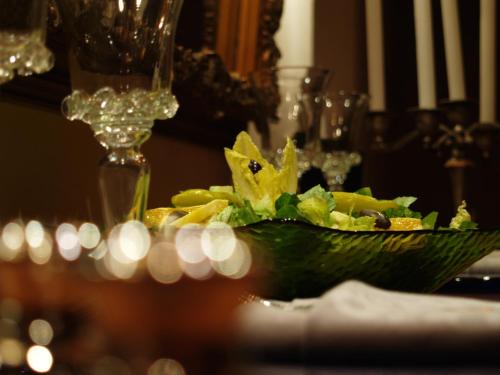a salad in a green bowl on a table at DonQuihotel Chalet in Karvounádhes