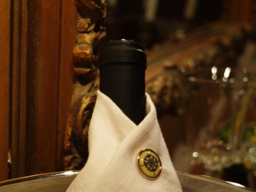 a bottle of wine wrapped in a napkin at DonQuihotel Chalet in Karvounádhes