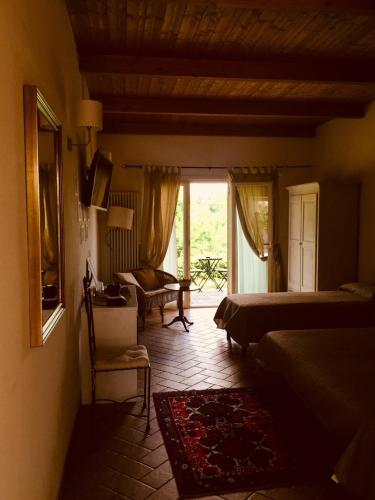 Ένα ή περισσότερα κρεβάτια σε δωμάτιο στο Agriturismo al Colle