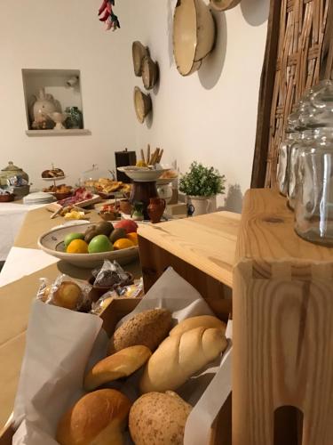 a table with many different types of bread on it at Aria di Casa Country Resort in Alberobello