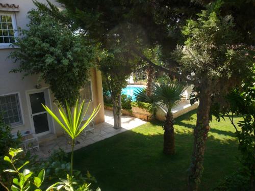 a view of a yard with trees and a pool at Greenfields Country Club in Limassol