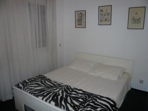 a bed in a room with a zebra blanket on it at Greenfields Country Club in Limassol
