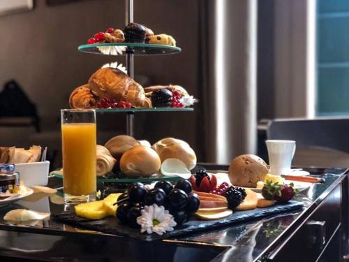 a table with a bunch of pastries and orange juice at Liassidi Wellness Suites in Venice