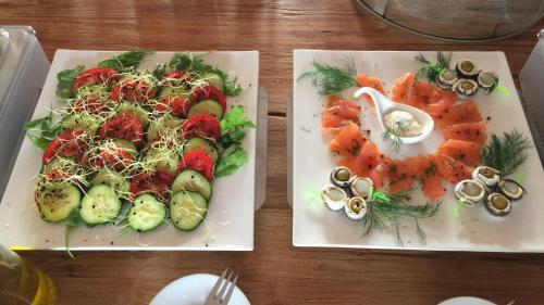 two plates of food with vegetables on a table at Agroturismo S Hort de Can Carrio AG226 in Ses Salines