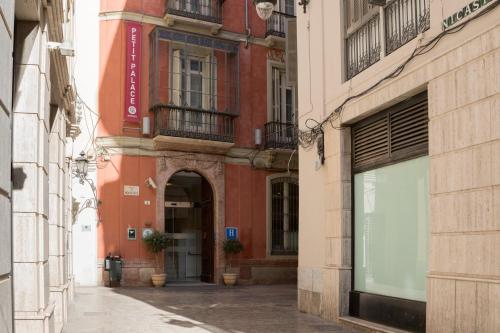 an alley in a city with a building at Petit Palace Plaza Málaga in Málaga