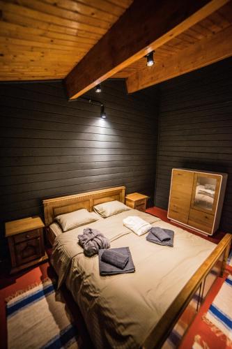 a bedroom with a large bed with towels on it at Enpi Lake Resort in Iaşi