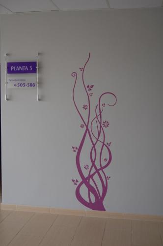 a wall mural with a vine design on a wall at Aparthotel Encasa in Madrid