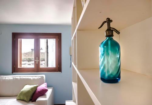 a large blue bottle sitting on the floor of a room at Dream House Duomo Catania in Catania