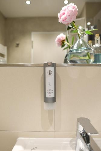 a remote control on a wall next to a sink at Apartment Central Leipzig - City in Leipzig