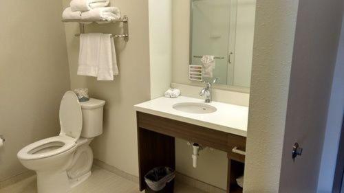 a bathroom with a toilet and a sink with a mirror at Extended Stay America Suites - Rock Hill in Rock Hill