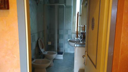 a bathroom with two toilets and a sink at Casale delle ginestre. in Castel Madama
