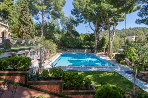 uma piscina num quintal com árvores em Apartamentos Gaudi Style em Náquera