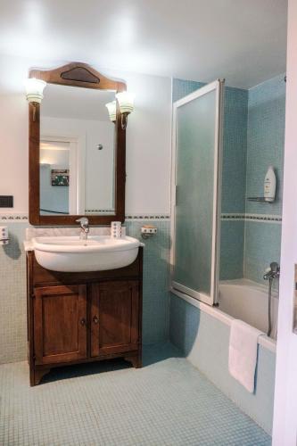 a bathroom with a sink and a shower at Dream House Duomo Catania in Catania