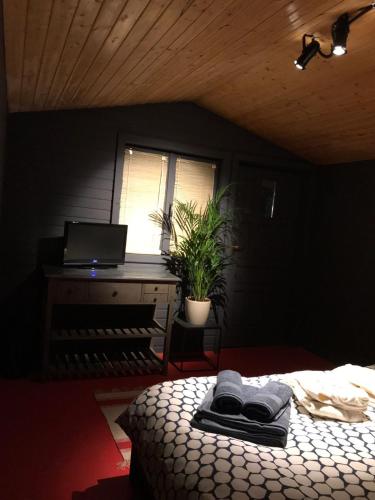 a bedroom with a bed and a desk with a laptop at Enpi Lake Resort in Iaşi