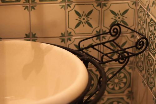 a bathroom with a sink and a tile wall at Régi Posta Hotel és Étterem in Debrecen