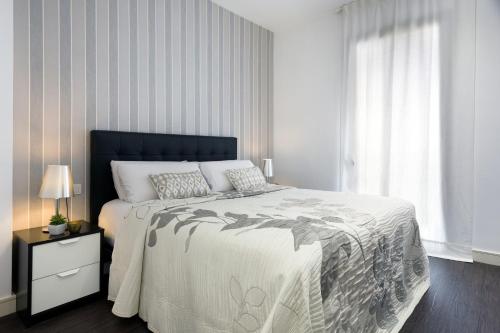 a bedroom with a large bed and a window at Catedral Bas Apartments by Aspasios in Barcelona