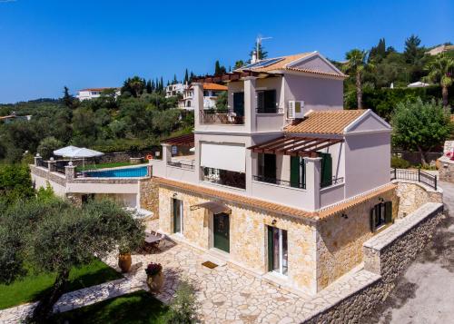 an aerial view of a villa with a swimming pool at Tesori Dassia Villas in Dassia