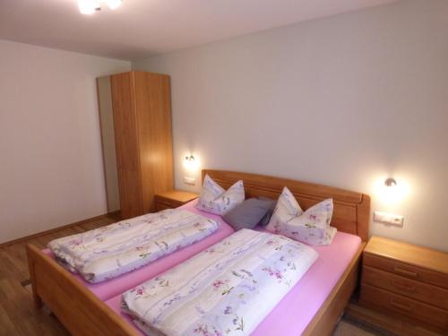a bedroom with two beds with pillows at Gillingerhof in Chamerau
