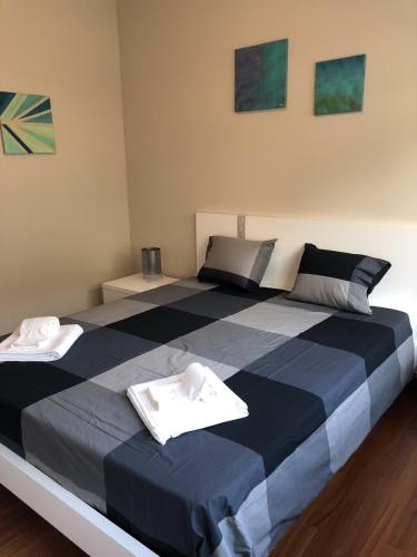 a large bed with two towels on top of it at Prestige Apartments by Quokka 360 - spacious flats with terraces in Lugano