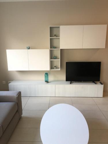 a living room with a couch and a tv at Prestige Apartments by Quokka 360 - spacious flats with terraces in Lugano