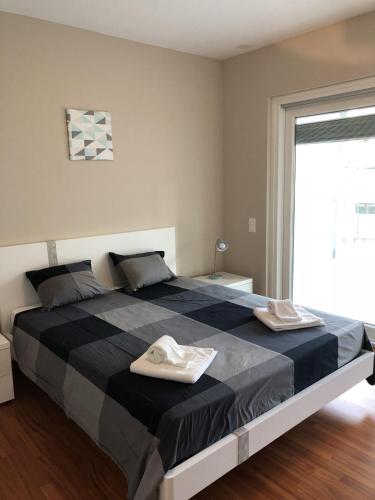 a bedroom with a large bed with two towels on it at Prestige Apartments by Quokka 360 - spacious flats with terraces in Lugano