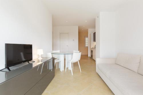 a living room with a couch and a table at Prestige Apartments by Quokka 360 - spacious flats with terraces in Lugano