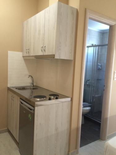 a small kitchen with a sink and a stove at Kleri Beloni Rooms in Chania Town