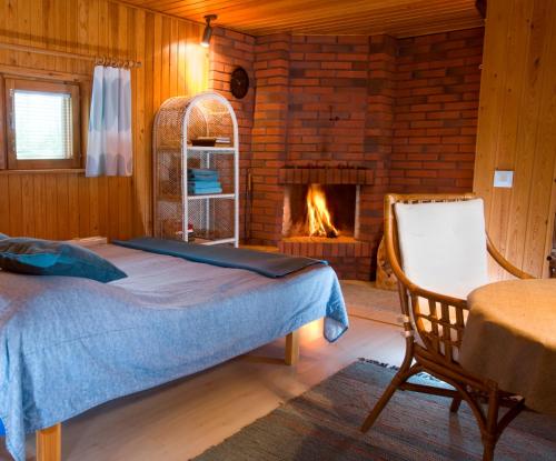 a bedroom with a bed and a fireplace at Casa Arctica Apartments in Rovaniemi