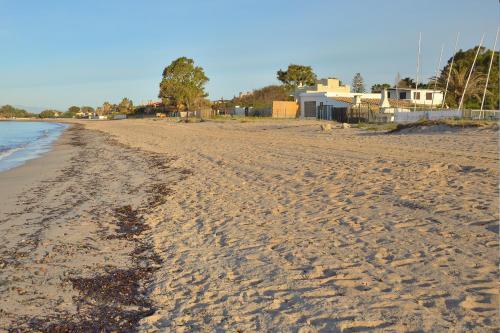 a sandy beach with footprints in the sand at Residence Mar Mediterraneo in Quartu SantʼElena