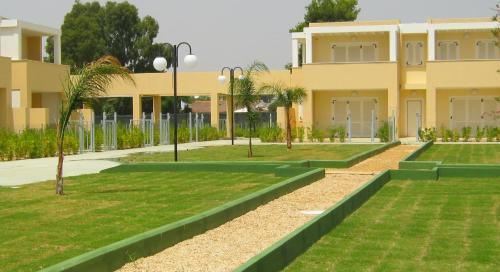 a house with a garden in front of it at Residence Mar Mediterraneo in Quartu SantʼElena