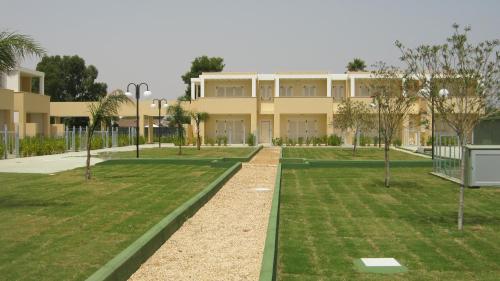 a building with a lawn in front of it at Residence Mar Mediterraneo in Quartu SantʼElena