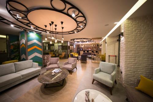 a living room with a couch and chairs and a table at Laren Family Hotel & Spa - Boutique Class in Antalya