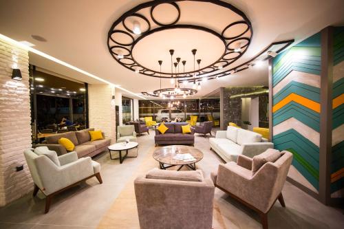 a lobby with couches and chairs and a chandelier at Laren Family Hotel & Spa - Boutique Class in Antalya