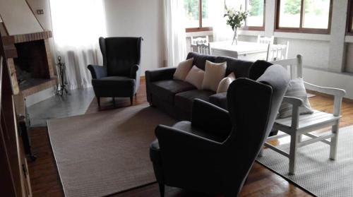 a living room with a couch and two chairs and a table at Iberik Casa Vilamor in Vilamor