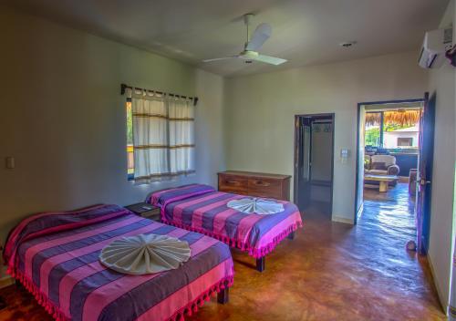 Katil atau katil-katil dalam bilik di Bungalows Oasis