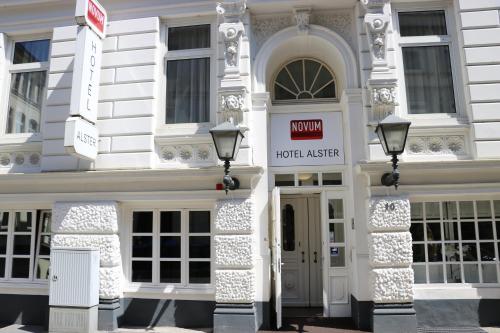a white building with a hotelier sign on it at Novum Hotel Alster Hamburg St. Georg in Hamburg