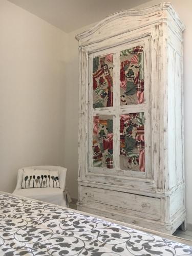 a white cabinet in a room with a bed at Carpe Diem in Portacomaro