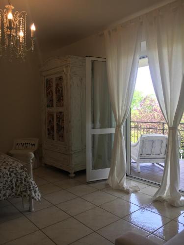 a bedroom with a sliding glass door to a balcony at Carpe Diem in Portacomaro