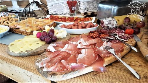 a table with many different types of meats and cheese at Casamare Hotel in San Vincenzo